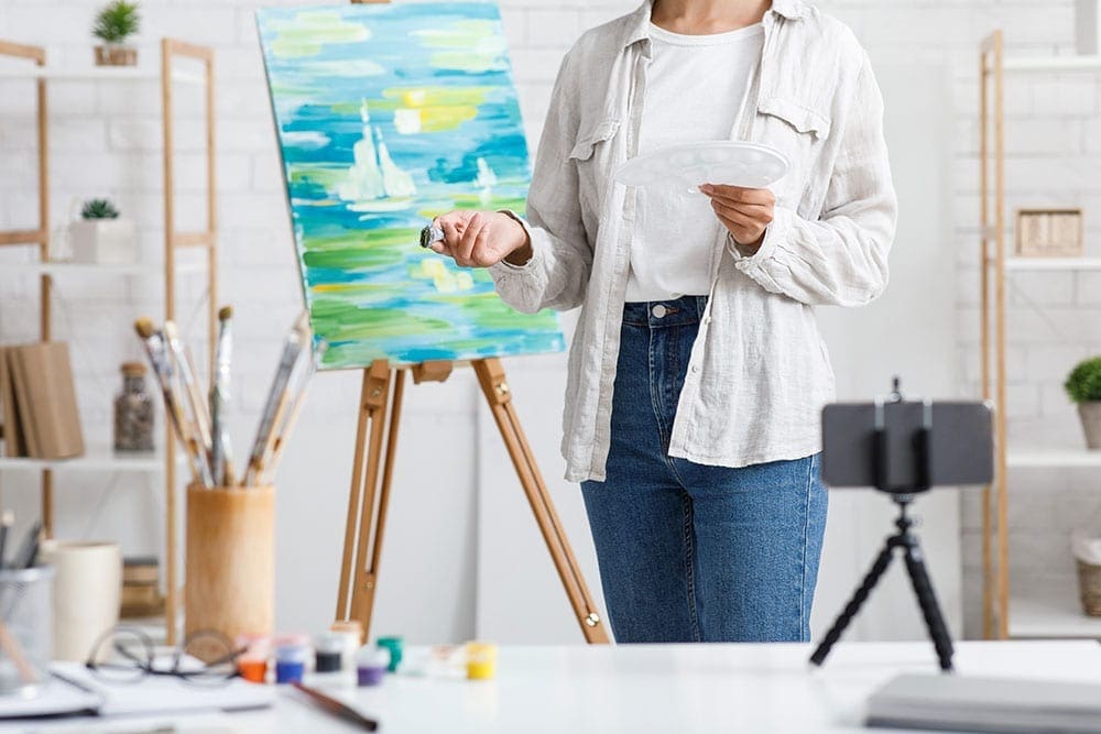 Woman teaching online painting class
